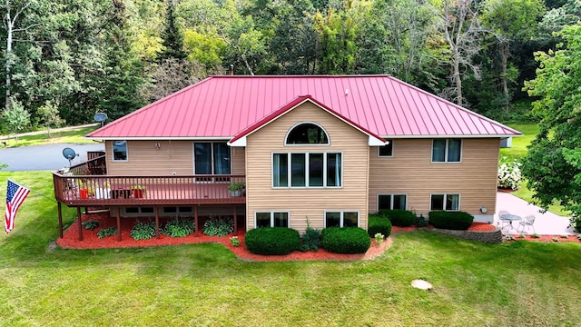 view of front of property featuring a standing seam roof, metal roof, a deck, and a front yard