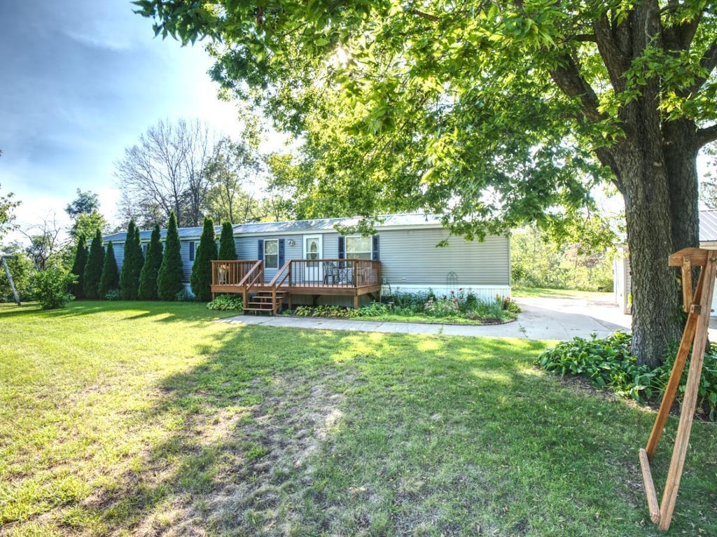 exterior space featuring a wooden deck and a front lawn