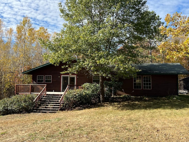 back of property with stairs, a lawn, and a wooden deck