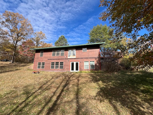 rear view of house with a yard