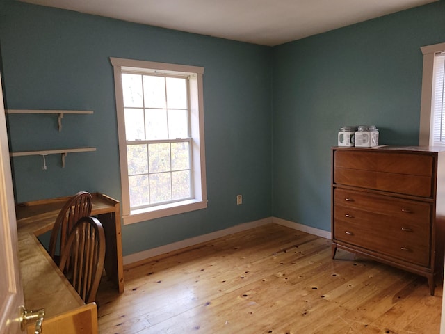 office space with light wood-style flooring and baseboards