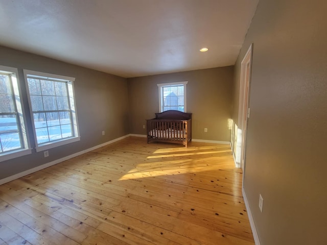 spare room with light wood-type flooring, baseboards, and recessed lighting