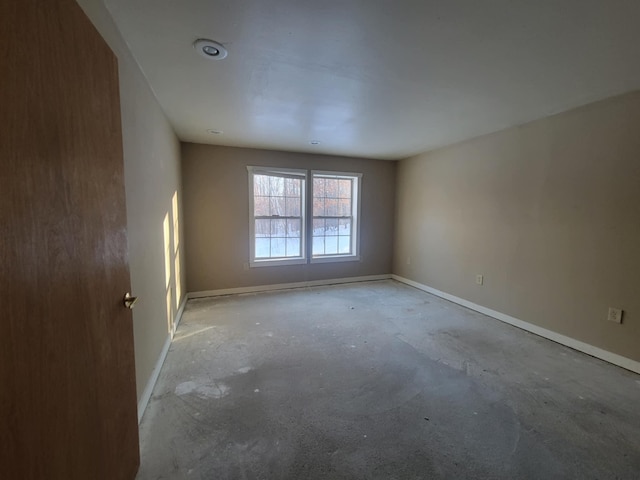 spare room with baseboards