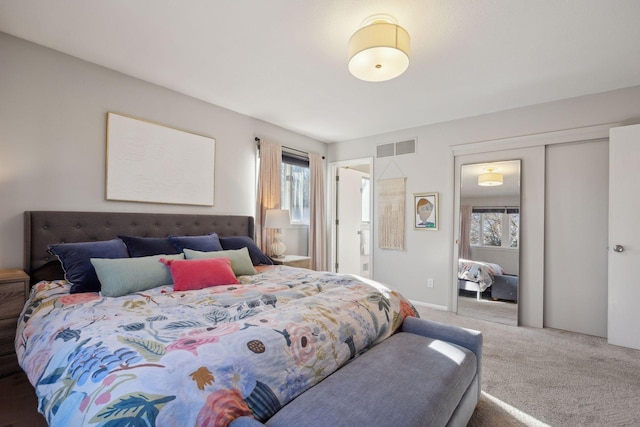 carpeted bedroom featuring visible vents