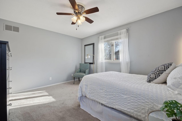 carpeted bedroom featuring baseboards, visible vents, and ceiling fan