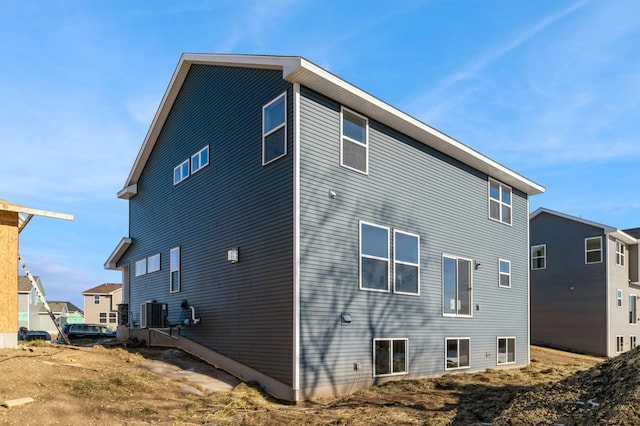 rear view of house with central air condition unit