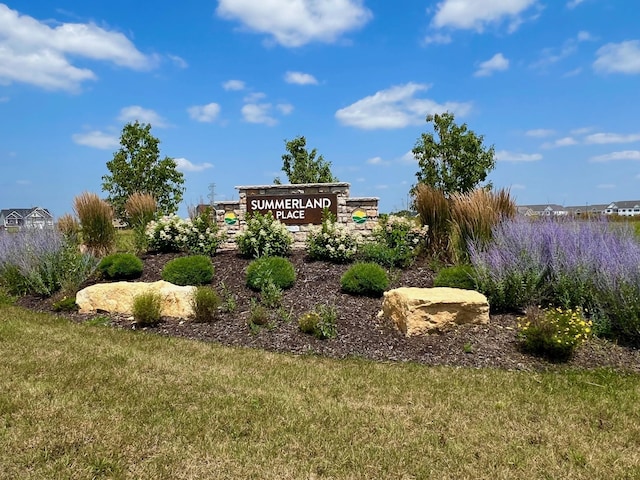 community sign featuring a lawn