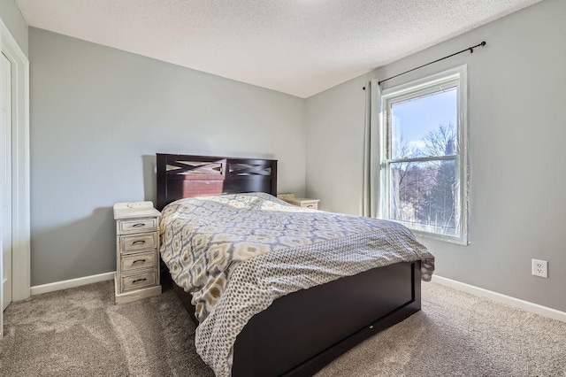 carpeted bedroom featuring a textured ceiling and baseboards