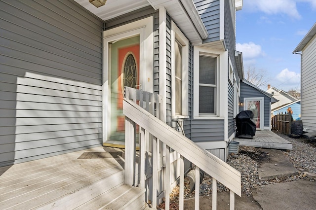 view of exterior entry with a deck