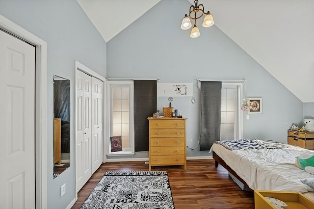 bedroom with a notable chandelier, a closet, high vaulted ceiling, and wood finished floors