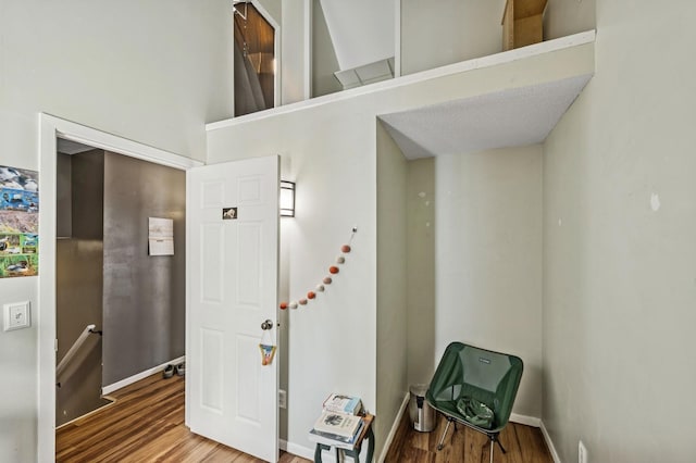 foyer entrance with wood finished floors and baseboards