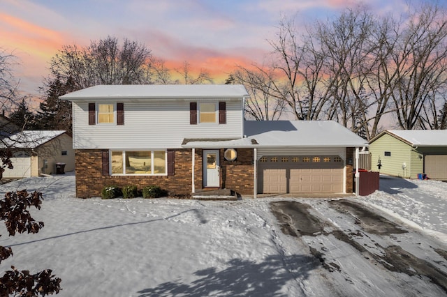 traditional-style house with a garage and brick siding