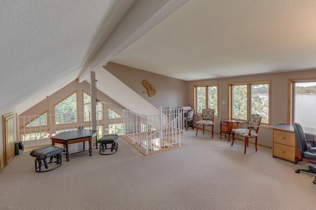 interior space with a textured ceiling, carpet flooring, and vaulted ceiling with beams