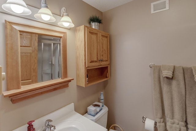 bathroom featuring visible vents and toilet