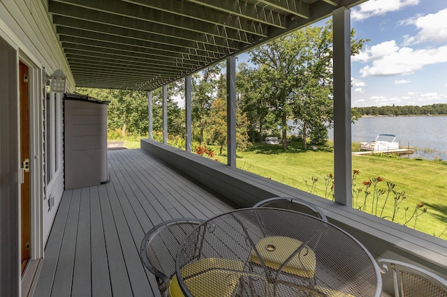 deck with a lawn and a water view