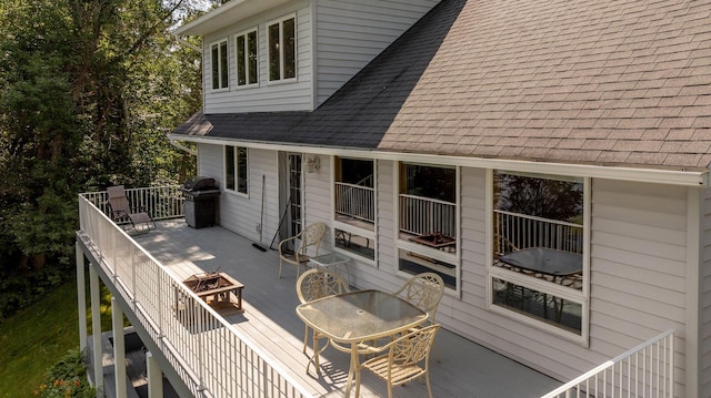 deck featuring outdoor dining area and area for grilling