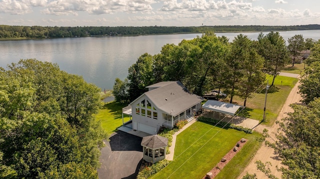 bird's eye view with a water view and a wooded view