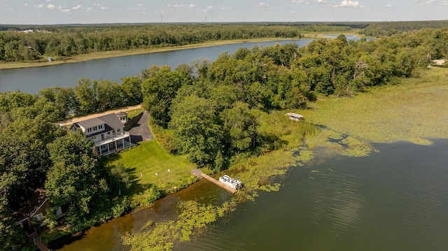 aerial view featuring a forest view and a water view