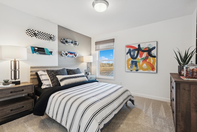 carpeted bedroom featuring baseboards