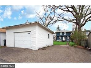 detached garage featuring aphalt driveway