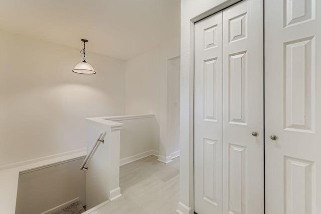 11570 Juniper St NW, Coon Rapids, MN 55448 - hallway with an upstairs landing and light wood-style flooring