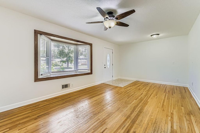 11570 Juniper St NW, Coon Rapids, MN 55448 - foyer featuring light wood-style floors, a ceiling fan, and a textured ceiling