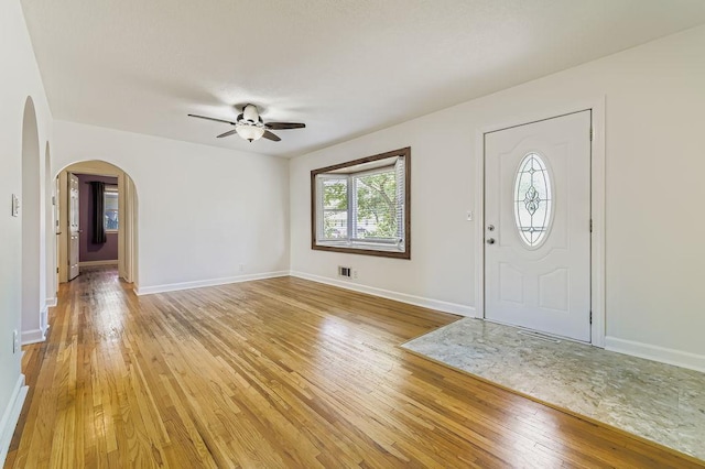 11570 Juniper St NW, Coon Rapids, MN 55448 - foyer with ceiling fan, arched walkways, light wood finished floors, and healthy amount of natural light