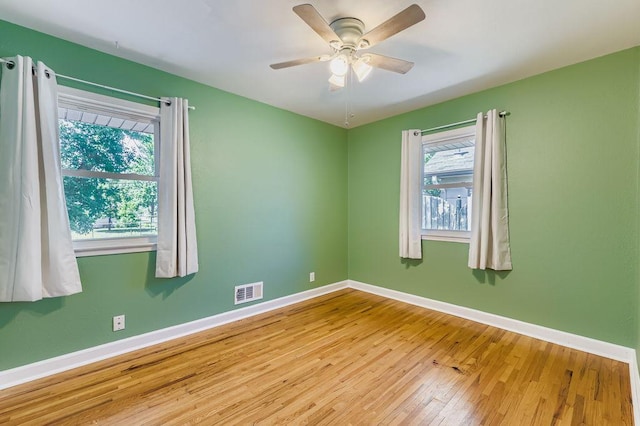 11570 Juniper St NW, Coon Rapids, MN 55448 - spare room with hardwood / wood-style flooring and ceiling fan