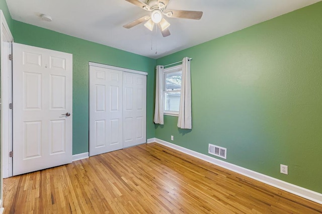 11570 Juniper St NW, Coon Rapids, MN 55448 - unfurnished bedroom with light wood-style floors, a closet, and a ceiling fan