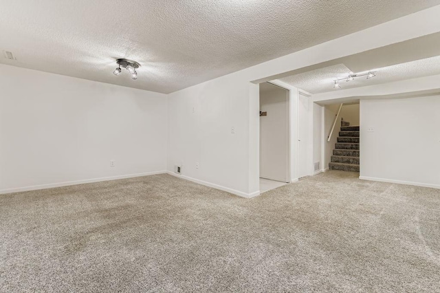 11570 Juniper St NW, Coon Rapids, MN 55448 - unfurnished room featuring a textured ceiling, stairway, and carpet floors