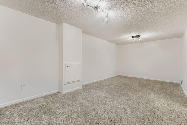 11570 Juniper St NW, Coon Rapids, MN 55448 - carpeted spare room with a textured ceiling and baseboards