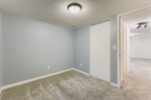 11570 Juniper St NW, Coon Rapids, MN 55448 - unfurnished bedroom featuring carpet, a textured ceiling, and a closet