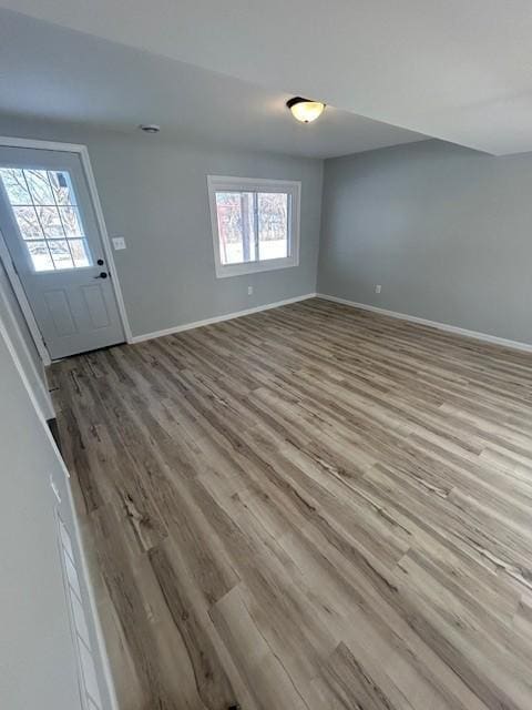 interior space with wood finished floors and baseboards