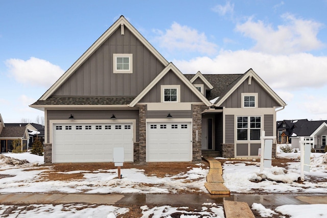 craftsman house with a garage, stone siding, a shingled roof, and board and batten siding