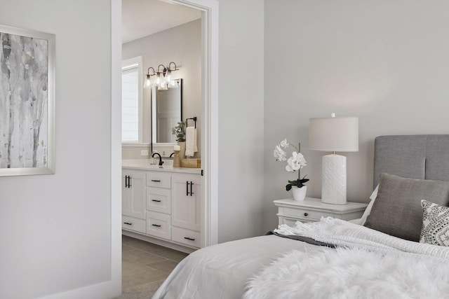 bedroom with light tile patterned floors and ensuite bath