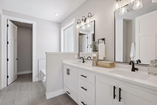 full bath with a garden tub, double vanity, a sink, and tile patterned floors