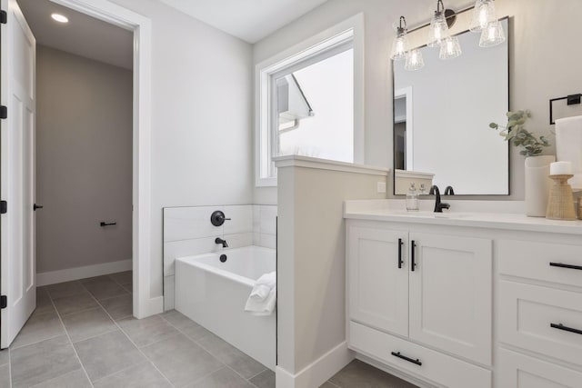 full bathroom with tile patterned flooring, vanity, baseboards, and a bath