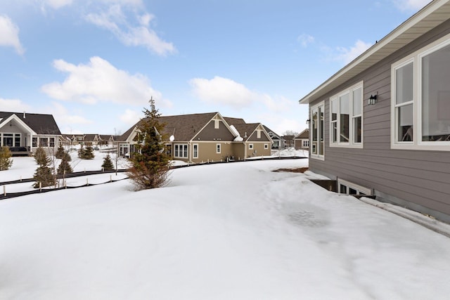 yard covered in snow with a residential view