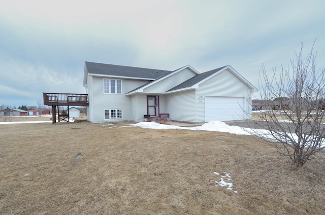 view of front of home featuring a garage, a deck, and a front yard