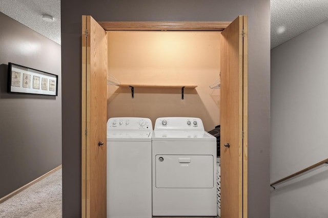 laundry area with a textured ceiling, laundry area, carpet floors, baseboards, and independent washer and dryer