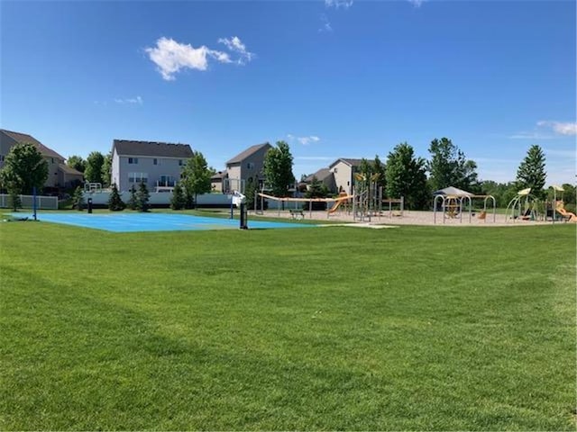 view of home's community with playground community, a yard, and volleyball court