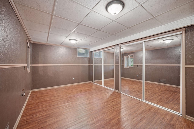 3415 197th Ave NW, Oak Grove, MN 55303 - unfurnished bedroom with wood finished floors, a paneled ceiling, a textured wall, and baseboards