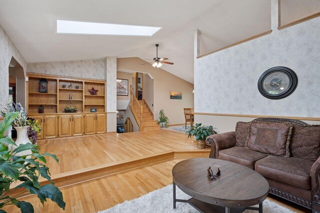 3415 197th Ave NW, Oak Grove, MN 55303 - living area featuring a skylight, light wood finished floors, stairs, vaulted ceiling, and a ceiling fan