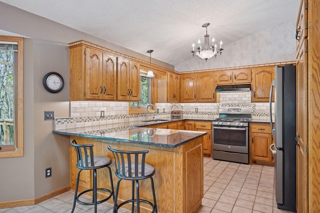 3415 197th Ave NW, Oak Grove, MN 55303 - kitchen with stainless steel appliances, a peninsula, under cabinet range hood, a sink, and light tile patterned floors