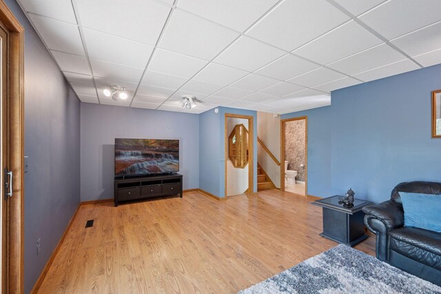 3415 197th Ave NW, Oak Grove, MN 55303 - living area featuring a drop ceiling, wood finished floors, stairway, and baseboards