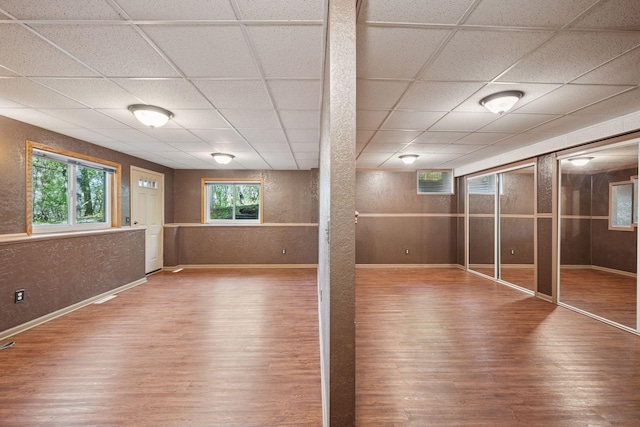 3415 197th Ave NW, Oak Grove, MN 55303 - below grade area with wood finished floors, a textured wall, a drop ceiling, and baseboards