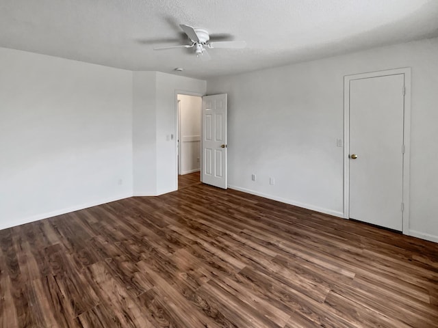 unfurnished bedroom featuring dark wood-style floors, ceiling fan, a textured ceiling, and baseboards