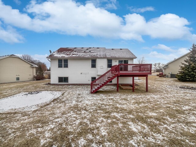 rear view of house featuring a deck and stairway