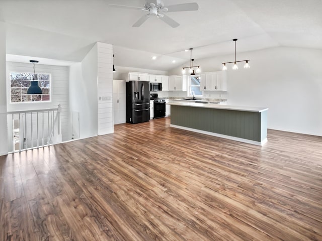 kitchen featuring dark wood-style flooring, white cabinetry, vaulted ceiling, light countertops, and black appliances