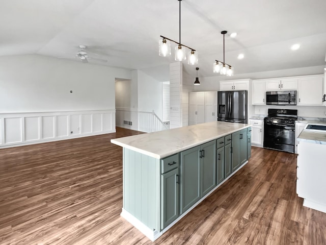 kitchen featuring lofted ceiling, dark wood-style flooring, a center island, black appliances, and white cabinetry